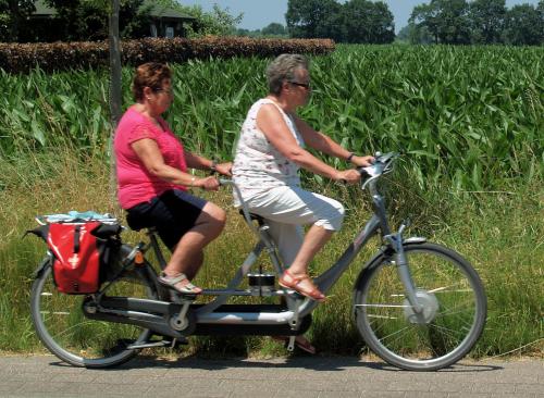 Corrie met Leny lekker in het zonnetje op de tandem