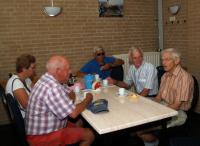 Sam, Marina, de twee mannen die de tocht voor Truus hadden uitgezet, en Geert aan de koffie